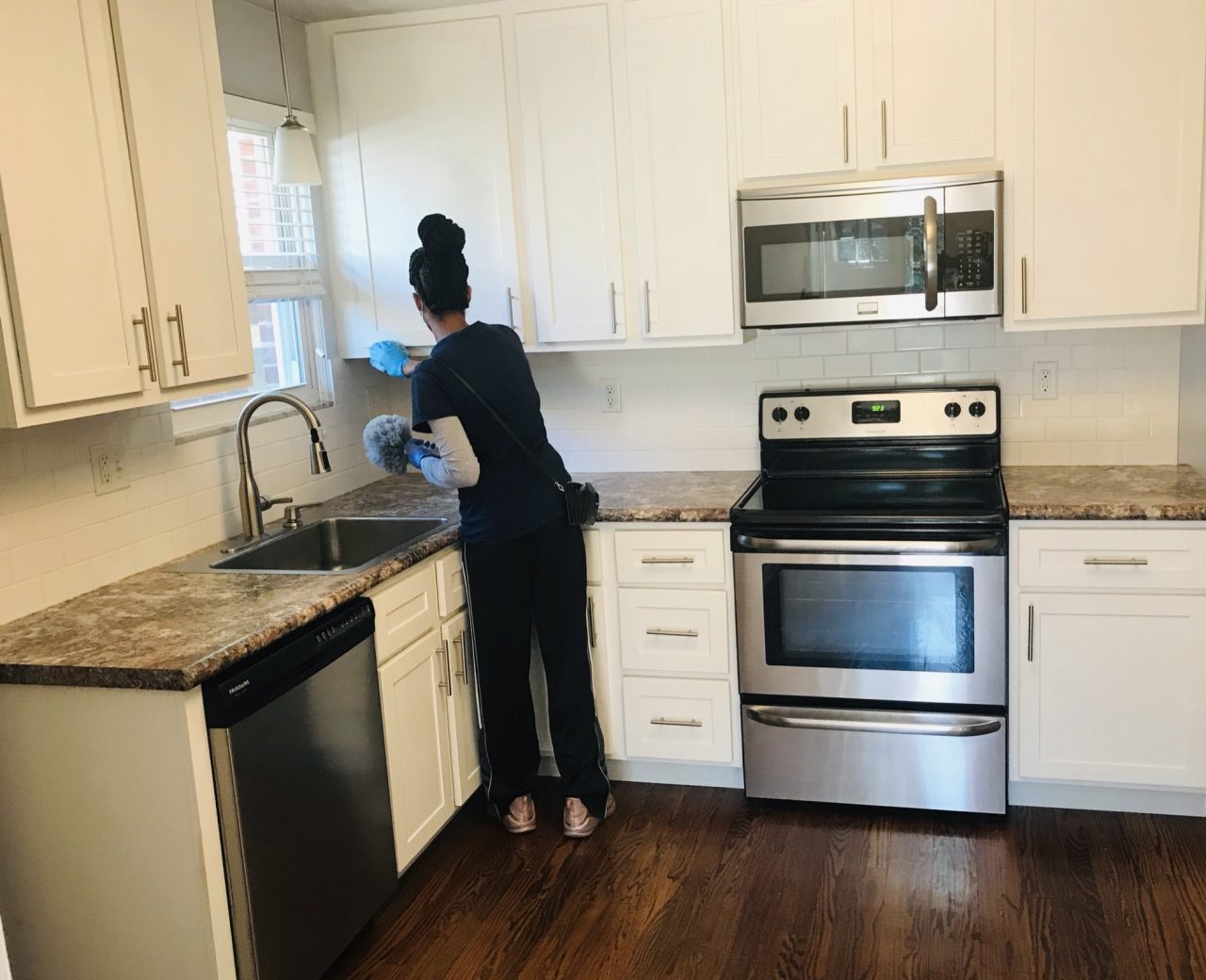 cleaning beutiful kitchen with stove and microwave
